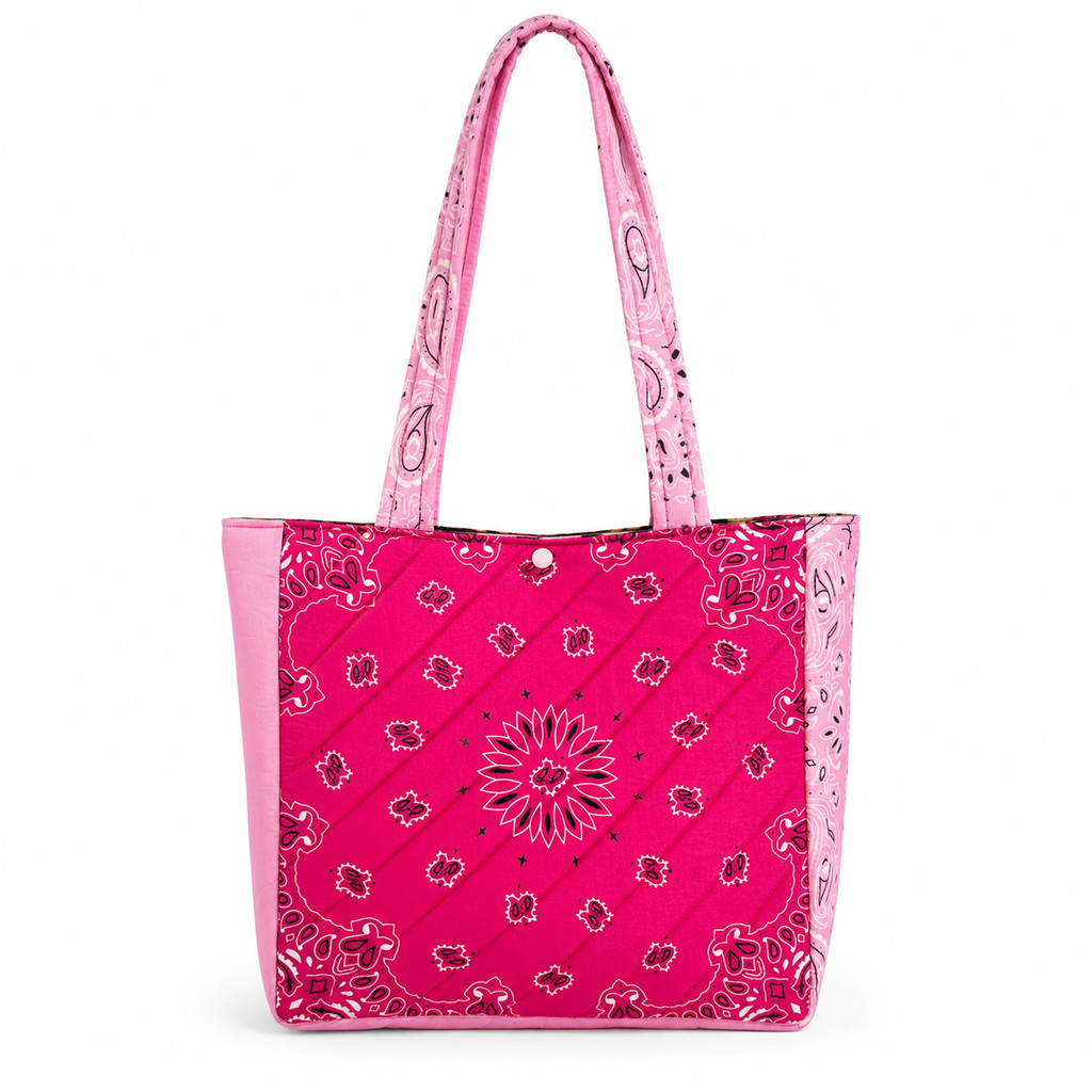 Handmade pink bandana quilted tote bag with light pink straps on white background.